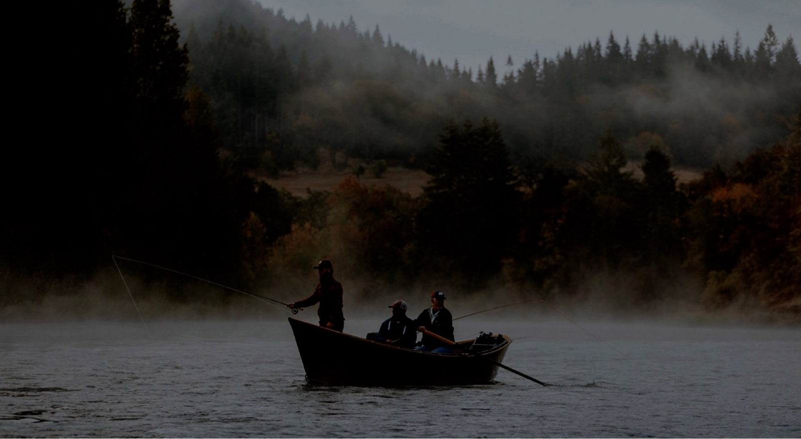 Under-exposed picture of fishermen in a boat on a lake